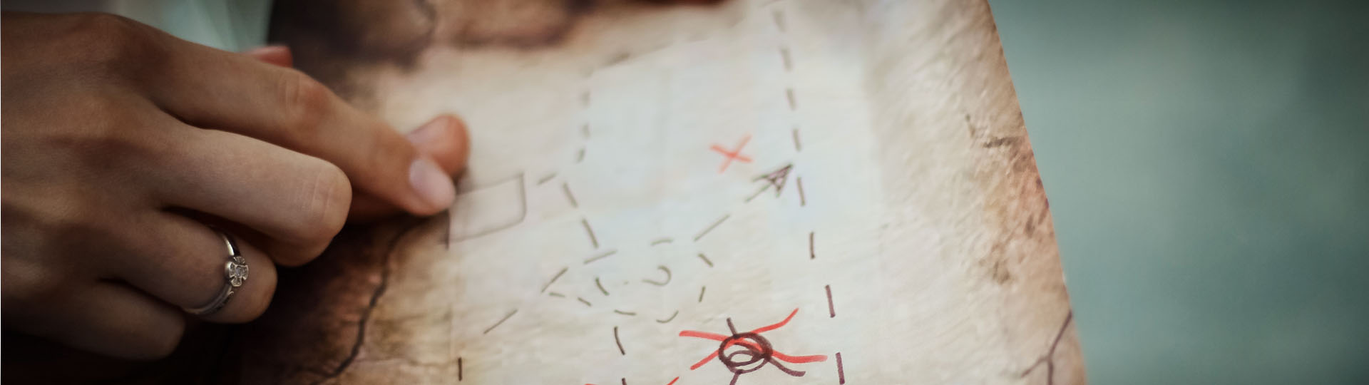 Hands Pointing at Old Map